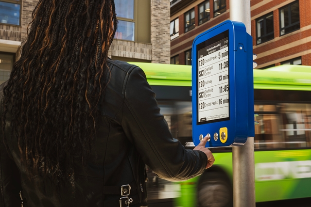 Woman pushing button at traffic light