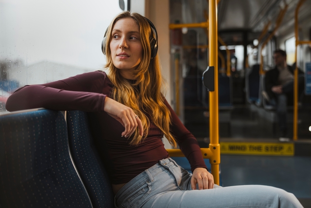 Woman listening to music on tram