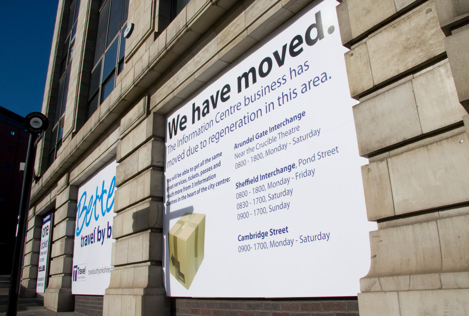 Building with sign saying 'We have moved'.