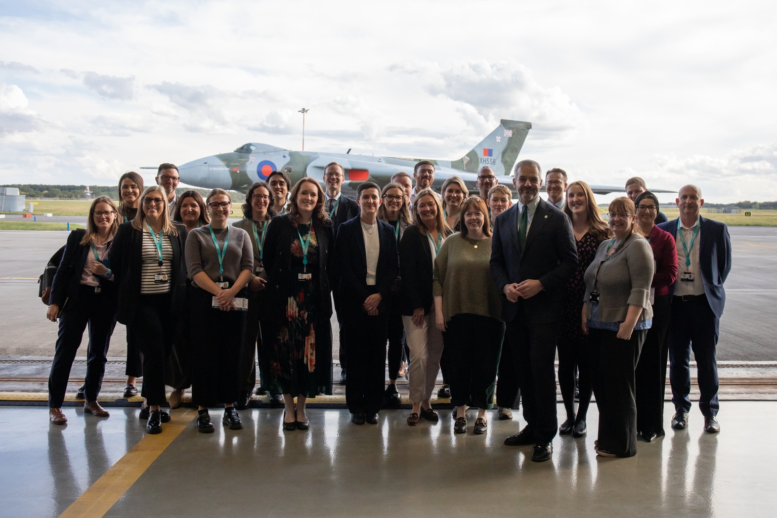 20 people stood next to a plane