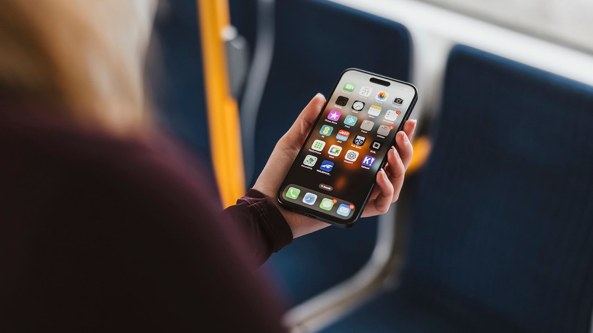 Woman using her mobile phone on a tram.